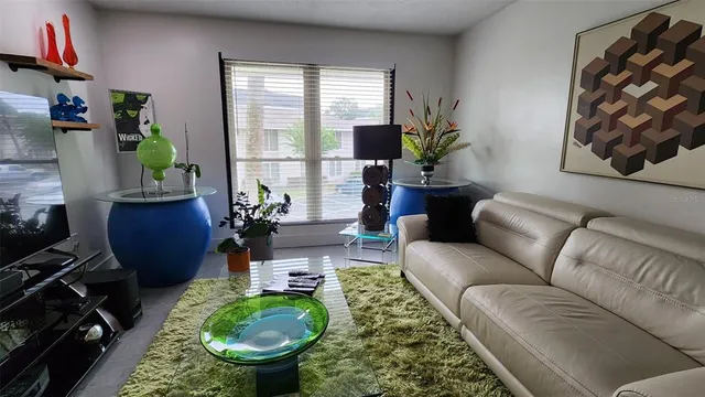 a living room with furniture and a potted plant