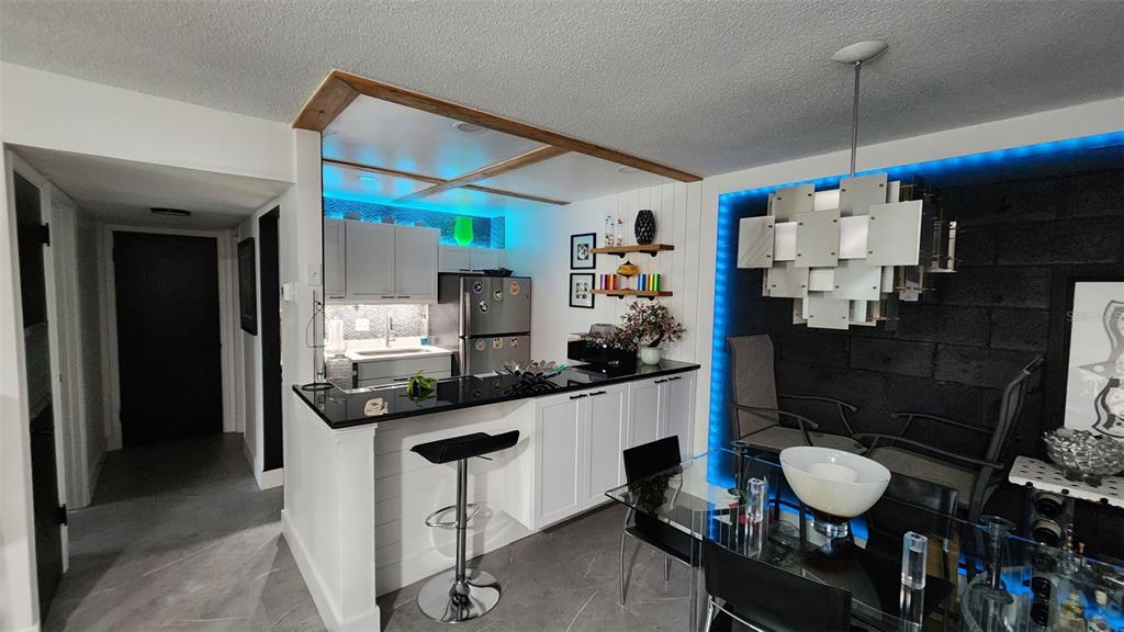 1935 South Conway Road, Unit T6 Orlando, FL 32812 - Photo 8 of 33 a kitchen with granite countertop a table and chairs in it