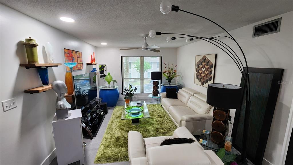 1935 South Conway Road, Unit T6 Orlando, FL 32812 - Photo 10 of 33 a living room with furniture a window and gym equipment