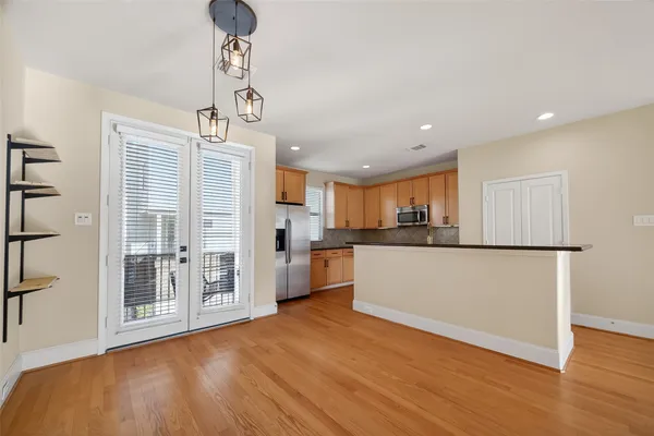 a view of kitchen with stainless steel appliances refrigerator oven and cabinets