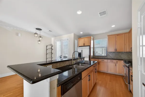 a kitchen with a sink stove and cabinets