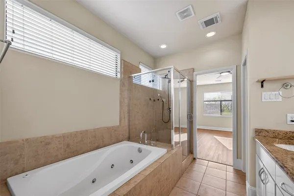 a bathroom with a bathtub and a shower