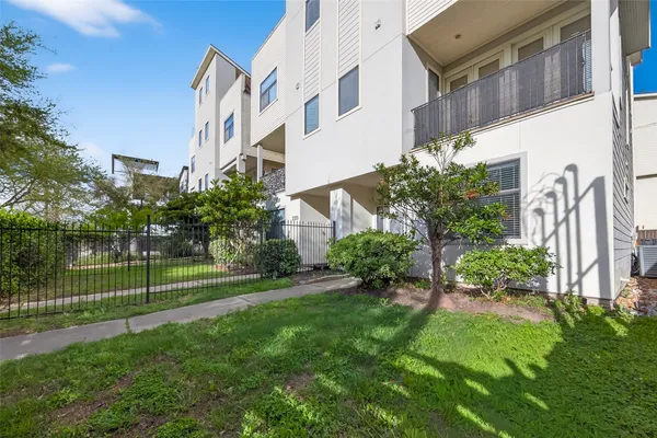 a view of a garden with a brick building in front of it