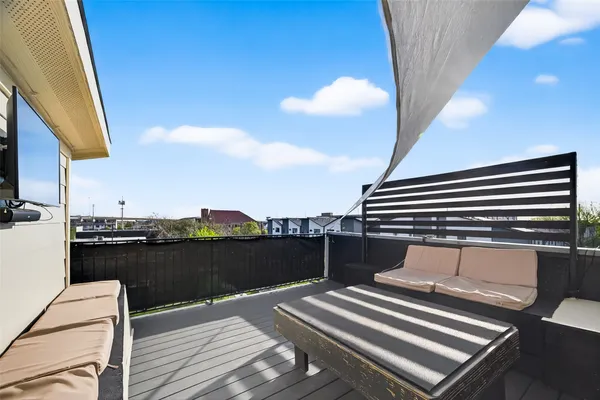 a terrace with outdoor seating and wooden floor