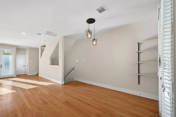 a view of a livingroom with wooden floor and a ceiling fan