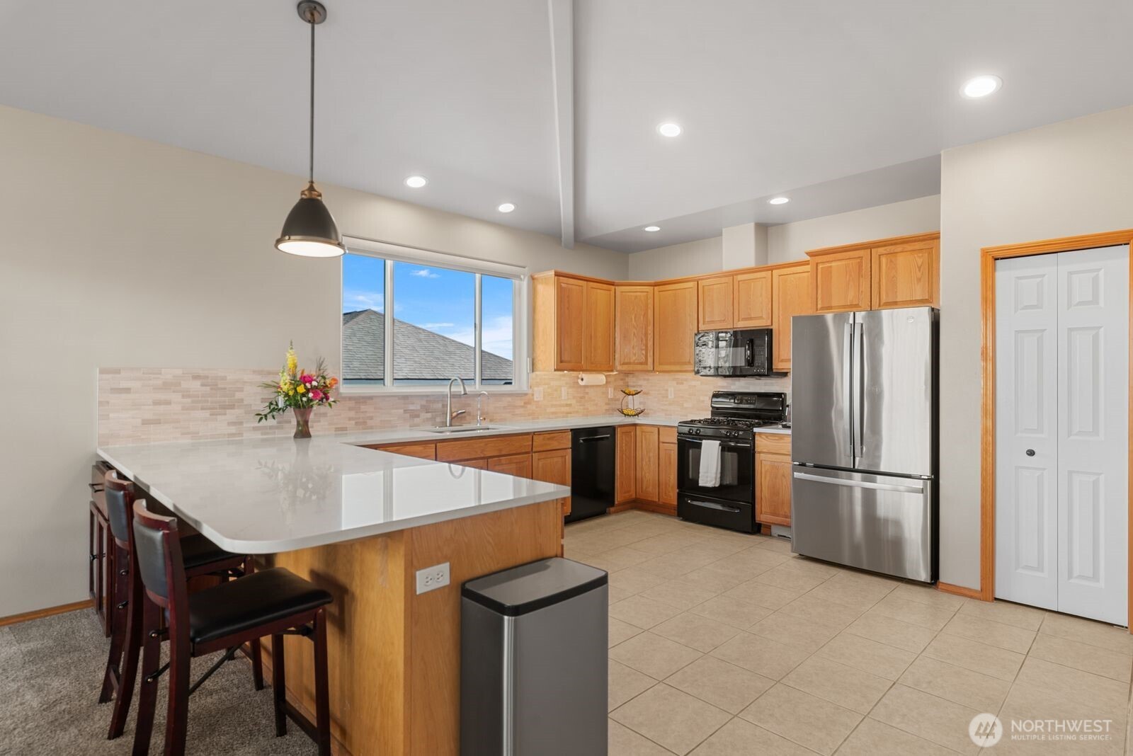 2220 Michael Brooke Wenatchee, WA 98801 - Photo 11 of 27 a kitchen with stainless steel appliances granite countertop a sink a stove a refrigerator and island with wooden floor