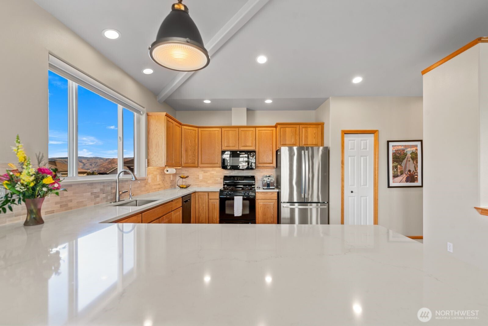 2220 Michael Brooke Wenatchee, WA 98801 - Photo 12 of 27 a kitchen with stainless steel appliances a large counter top a stove and a sink