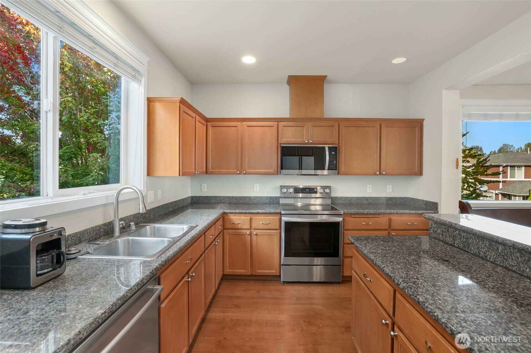 142 Spruce Street Tacoma, WA 98466 - Photo 14 of 31 a kitchen with stainless steel appliances granite countertop a sink stove and cabinets