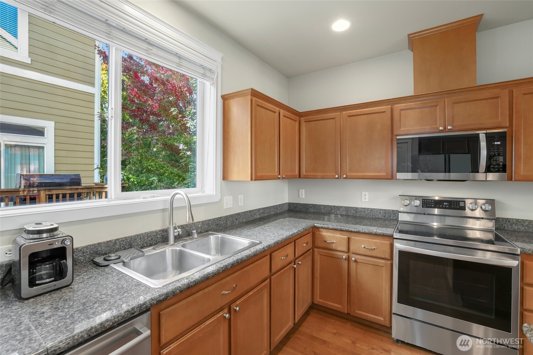 142 Spruce Street Tacoma, WA 98466 - Photo 15 of 31 a kitchen with stainless steel appliances granite countertop a sink and a stove