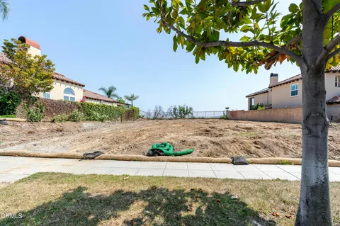 a bed sitting in a bedroom next to a lamp