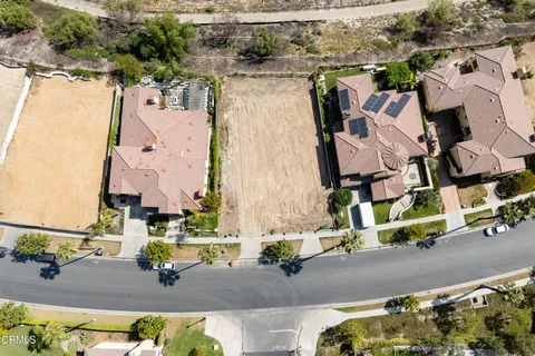 an aerial view of a house a yard and lake view