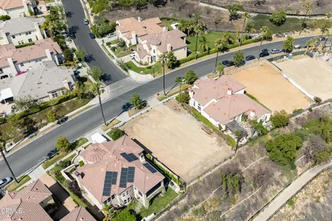 an aerial view of a house with a yard