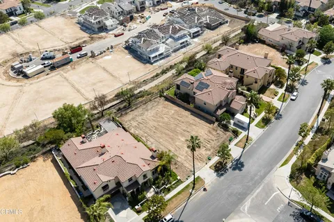 an aerial view of a house with a yard