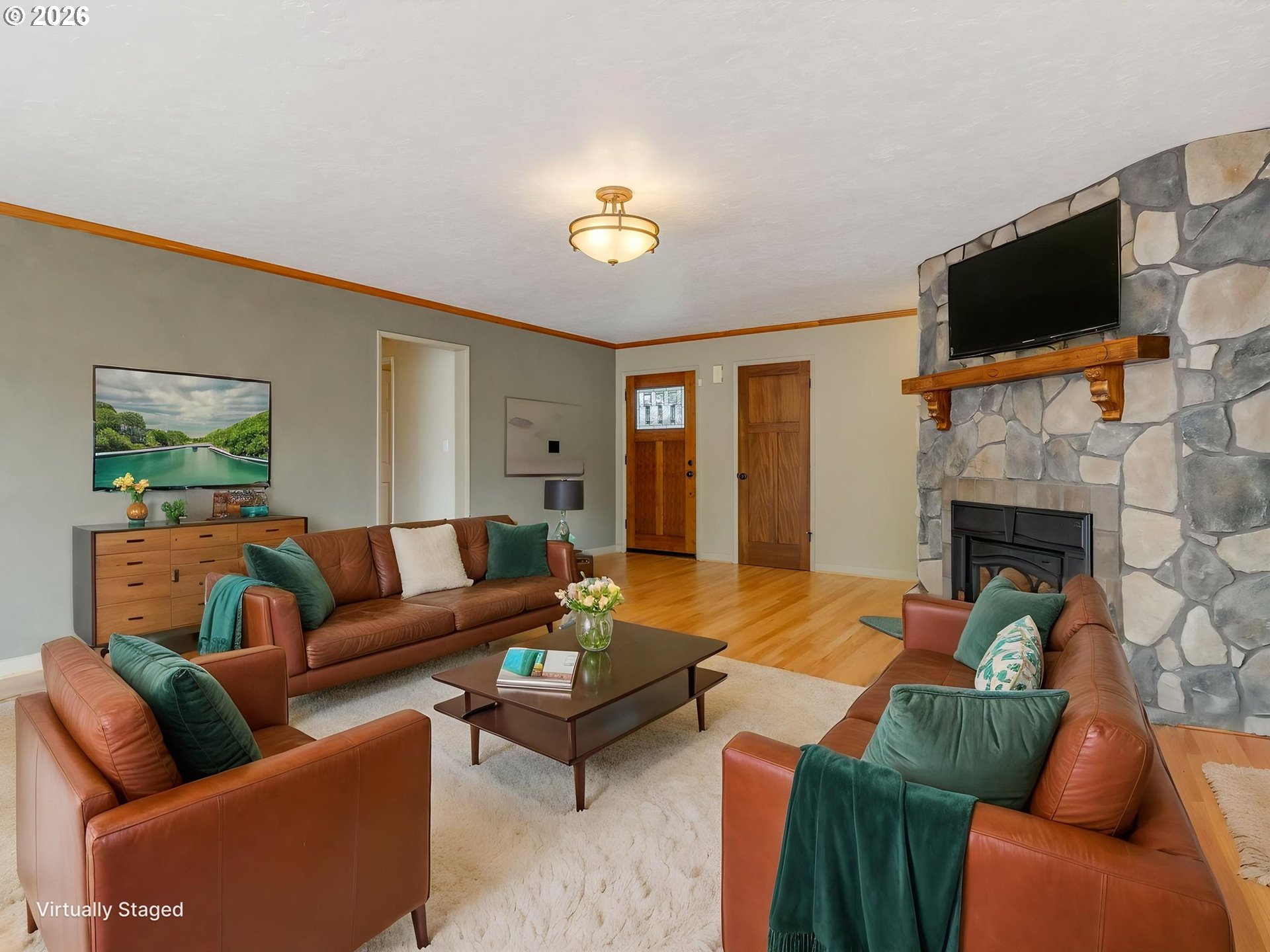 48140 Southeast Linhart Butte Road Sandy, OR 97055 - Photo 16 of 47 a living room with furniture a flat screen tv and a fireplace
