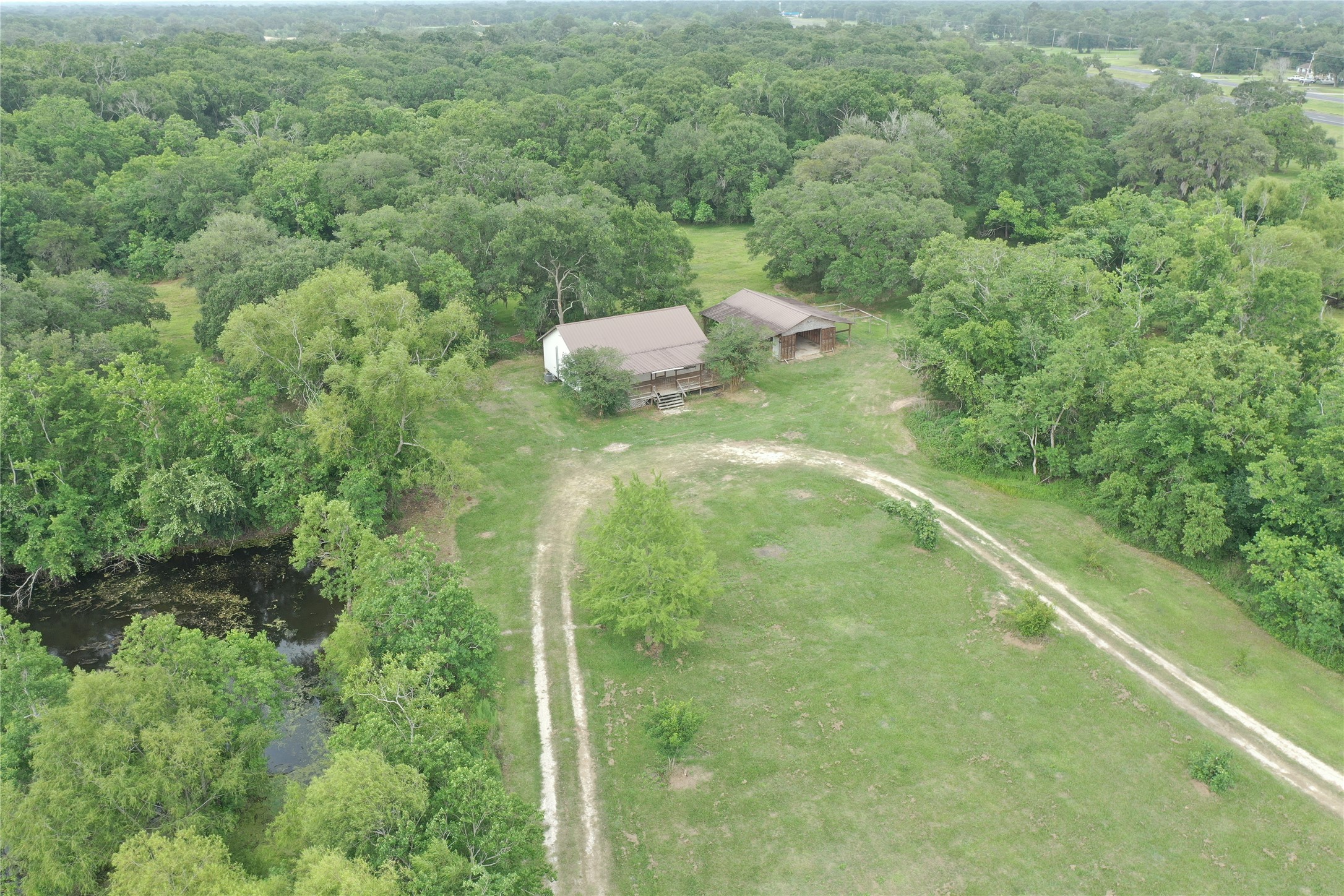 20146 Highway 35 Sweeny, TX 77480 - Photo 29 of 44 a view of a forest with a street