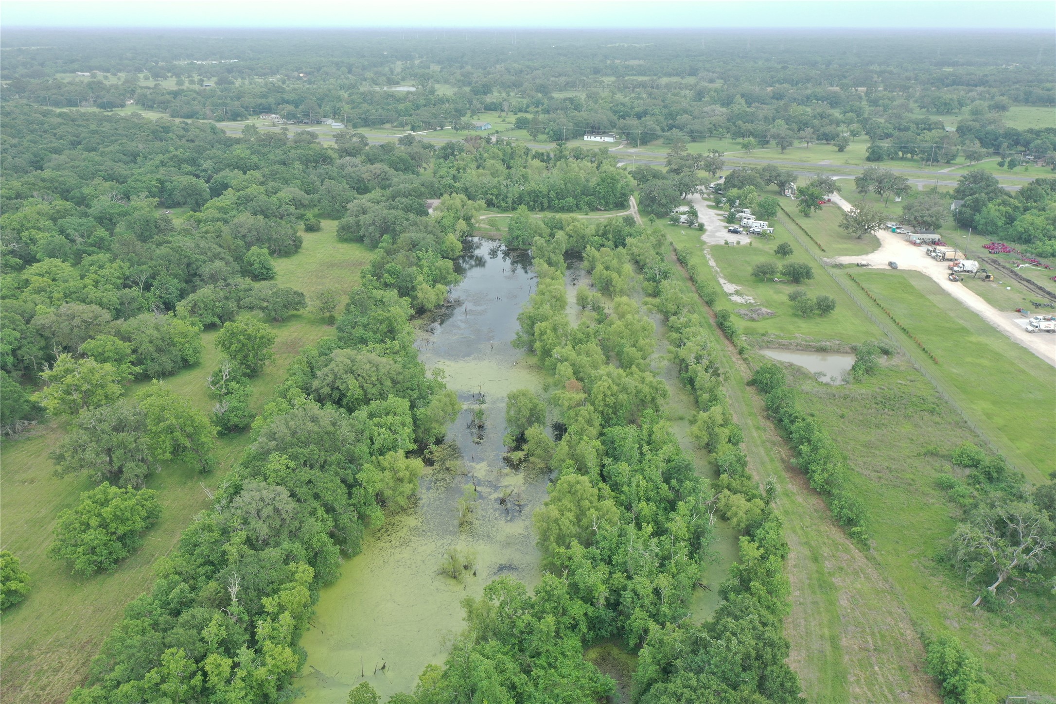 20146 Highway 35 Sweeny, TX 77480 - Photo 32 of 44 an aerial view of residential houses with outdoor space and trees