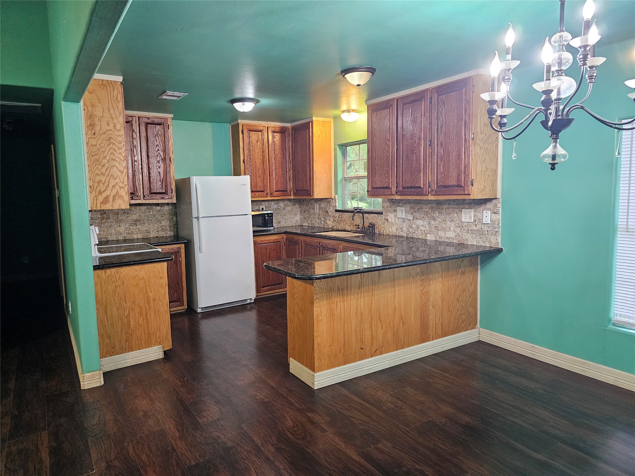 20146 Highway 35 Sweeny, TX 77480 - Photo 7 of 44 a kitchen with kitchen island granite countertop wooden floors stainless steel appliances and sink