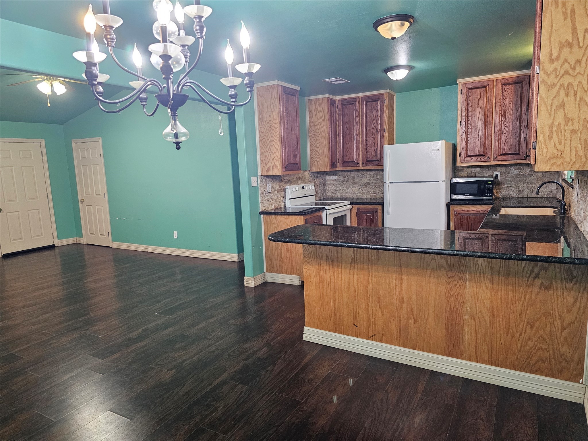 20146 Highway 35 Sweeny, TX 77480 - Photo 8 of 44 a kitchen with kitchen island granite countertop wooden cabinets a refrigerator and a sink