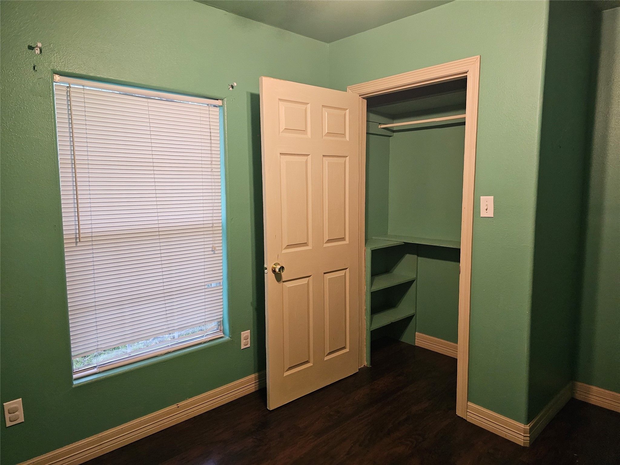 20146 Highway 35 Sweeny, TX 77480 - Photo 9 of 44 a view of an empty room with wooden floor and a window
