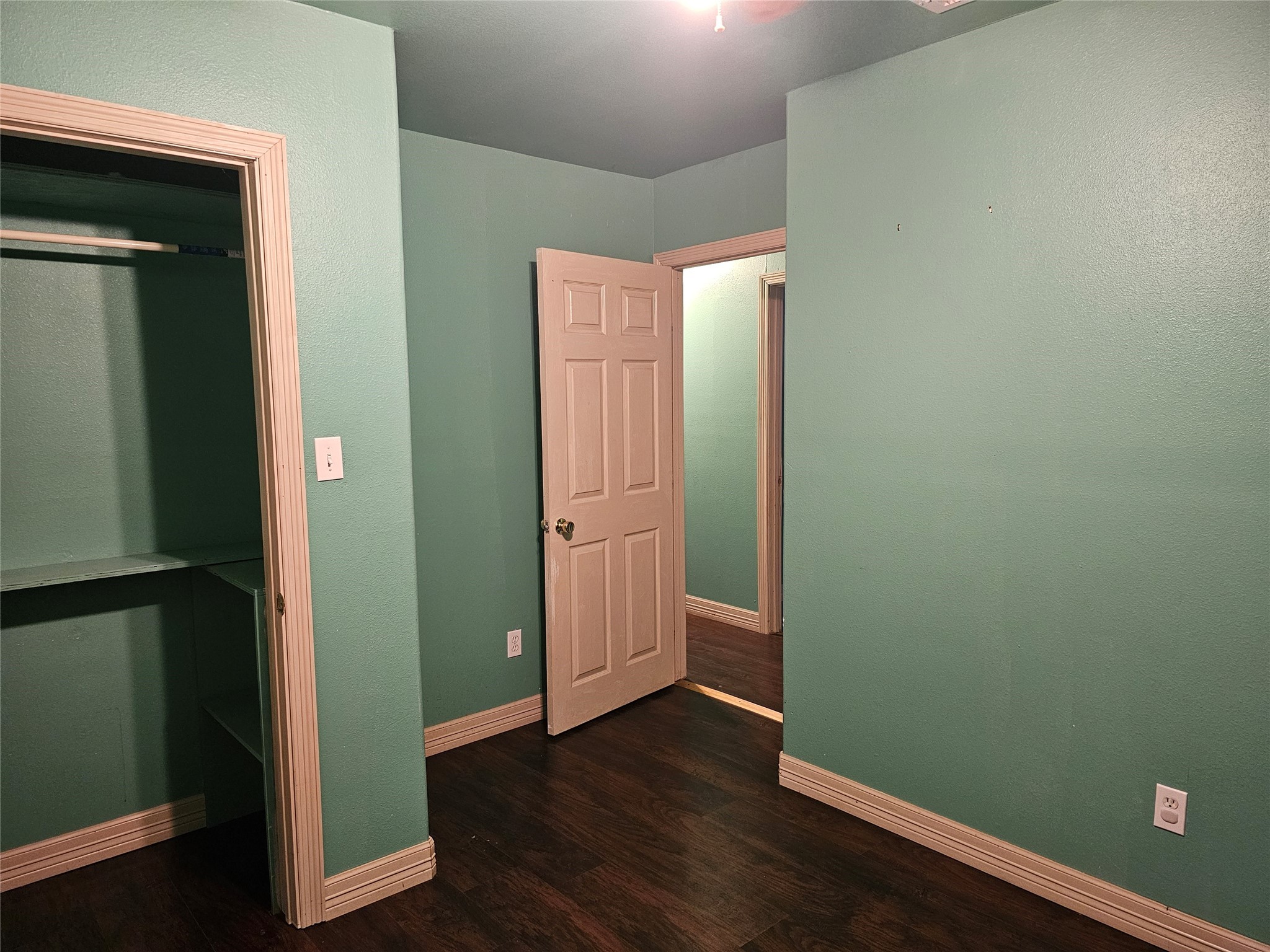 20146 Highway 35 Sweeny, TX 77480 - Photo 10 of 44 an empty room with wooden floor & closet and a bathroom