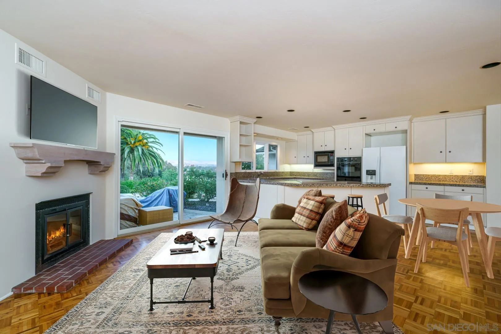 6531 Lago Lindo Rancho Santa Fe, CA 92067 - Photo 15 of 53 a living room with furniture a flat screen tv and a fireplace
