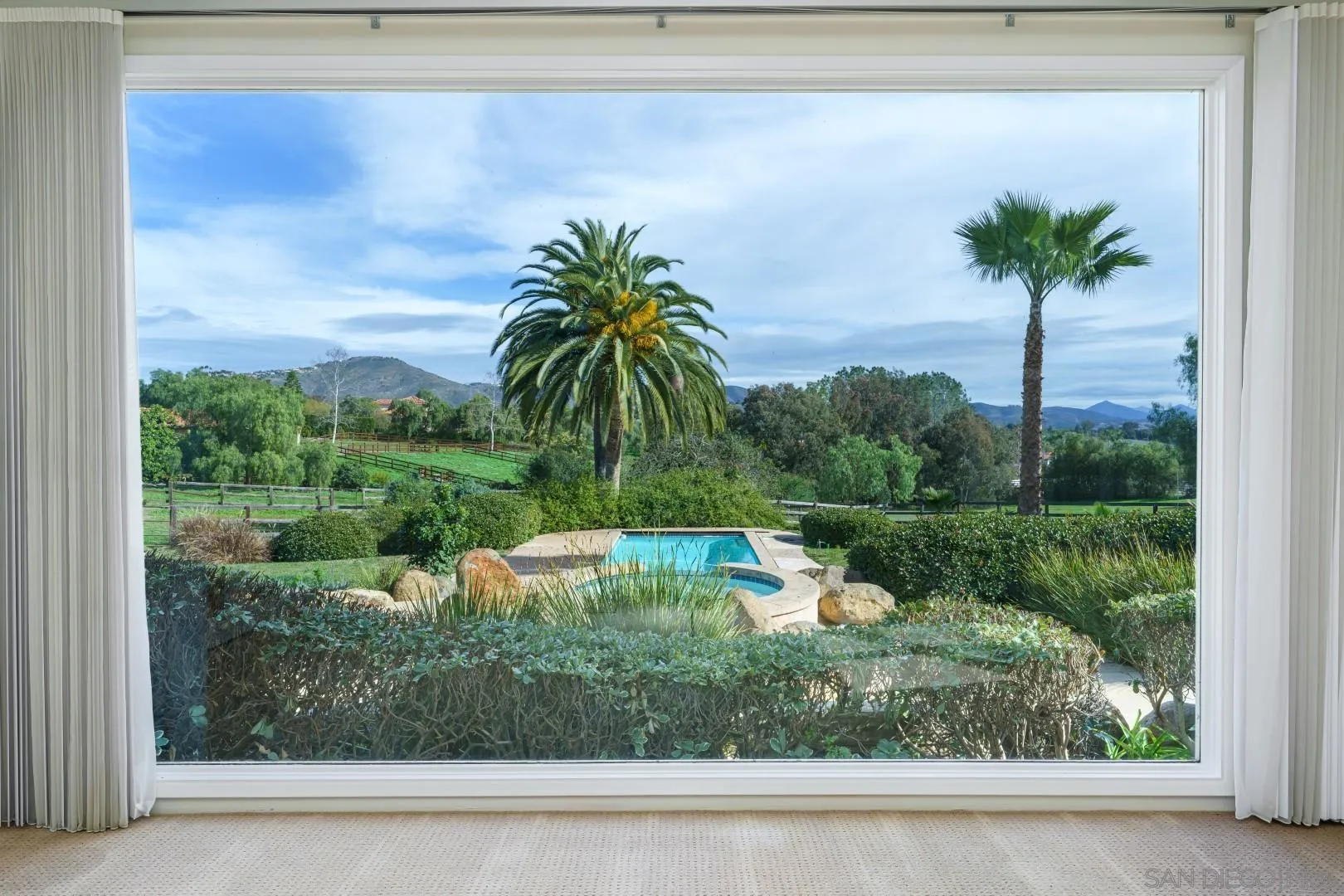 6531 Lago Lindo Rancho Santa Fe, CA 92067 - Photo 2 of 53 a view of a swimming pool with a yard and palm trees