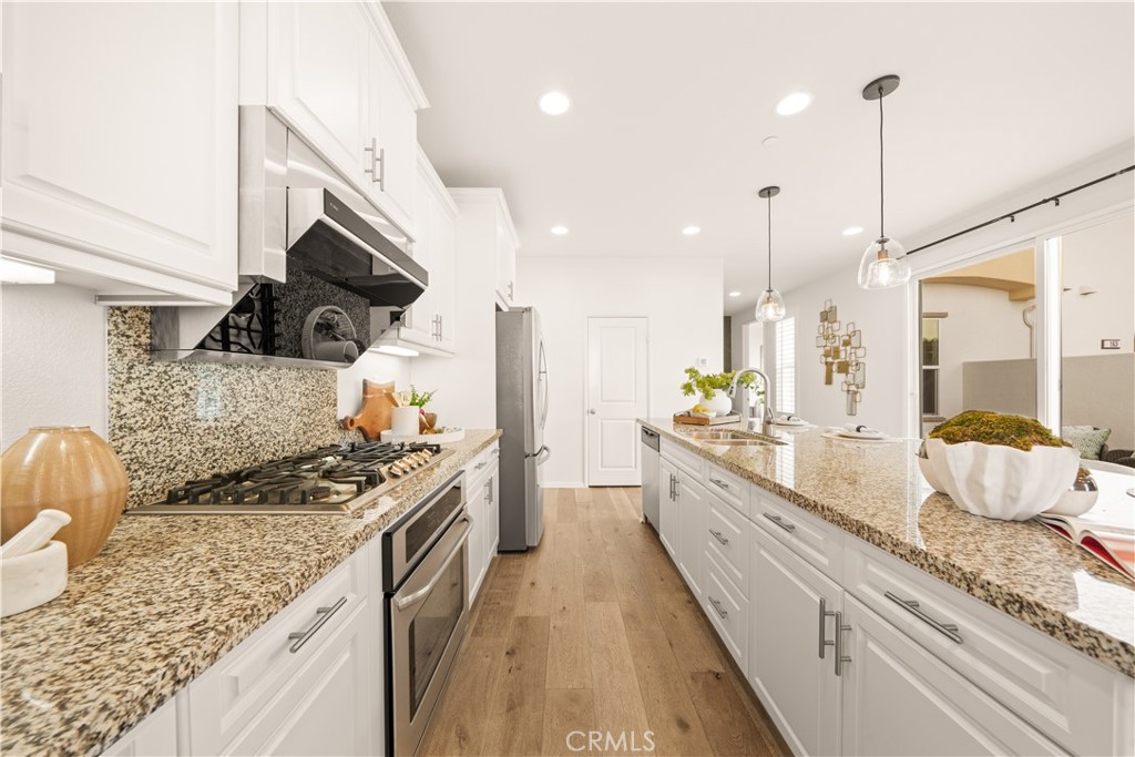 161 Fixie Irvine, CA 92618 - Photo 13 of 47 a kitchen with stainless steel appliances granite countertop a stove a sink and a wooden floor