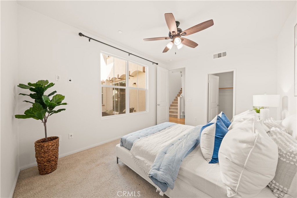 161 Fixie Irvine, CA 92618 - Photo 15 of 47 a bedroom with a large bed and a potted plant