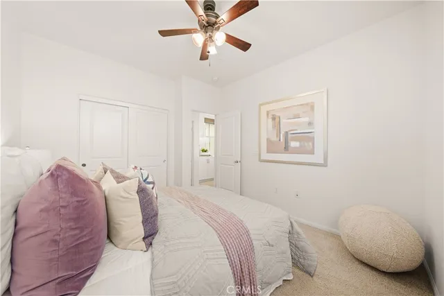 a bathroom with a granite countertop sink a toilet and a mirror
