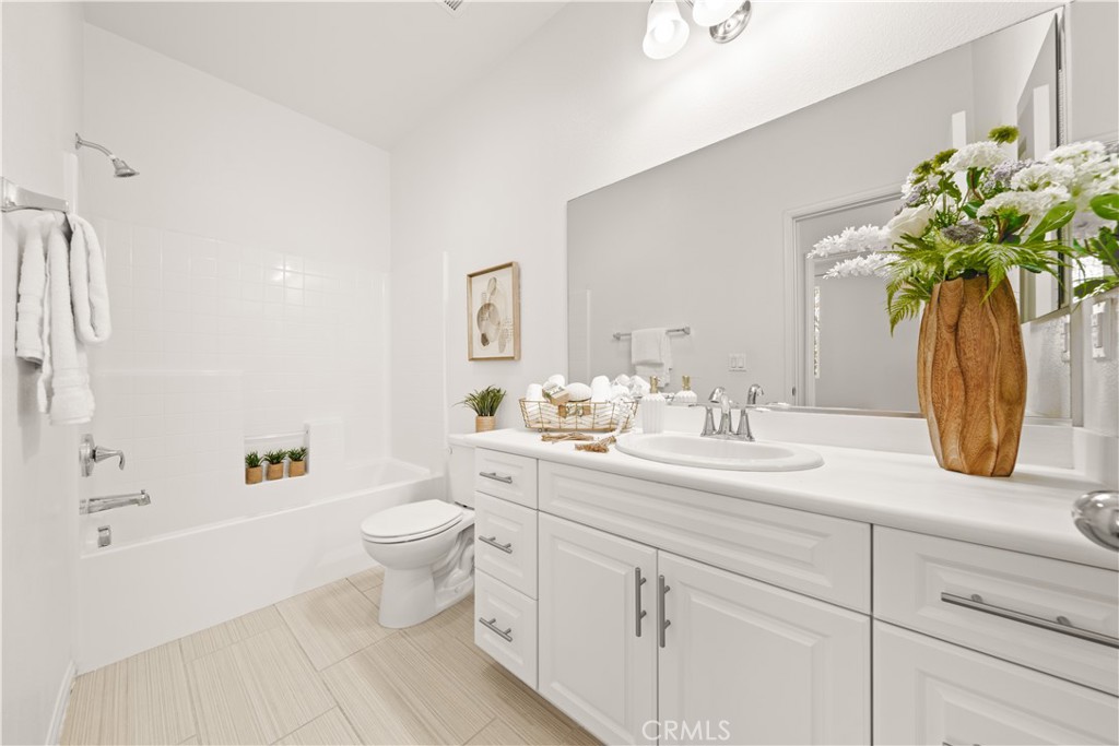 161 Fixie Irvine, CA 92618 - Photo 34 of 47 a bathroom with a granite countertop sink a toilet and a mirror