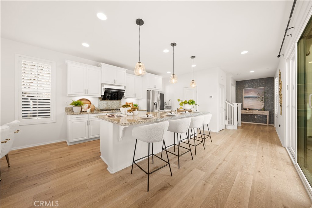 161 Fixie Irvine, CA 92618 - Photo 10 of 47 a kitchen with stainless steel appliances a dining table chairs stove and white cabinets