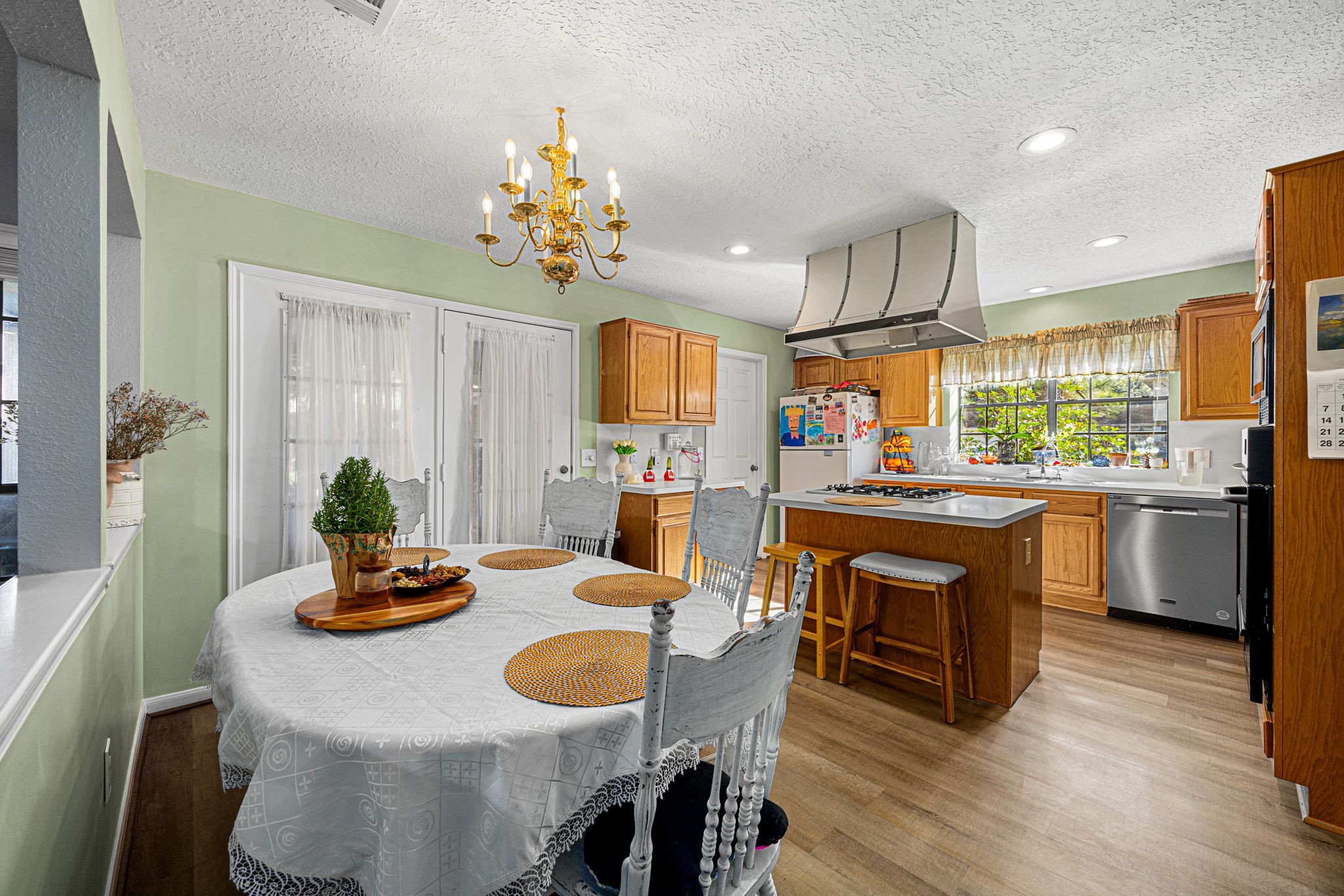 3402 Deeds Road Houston, TX 77084 - Photo 11 of 35 a open dining room with stainless steel appliances kitchen island granite countertop furniture and wooden floor