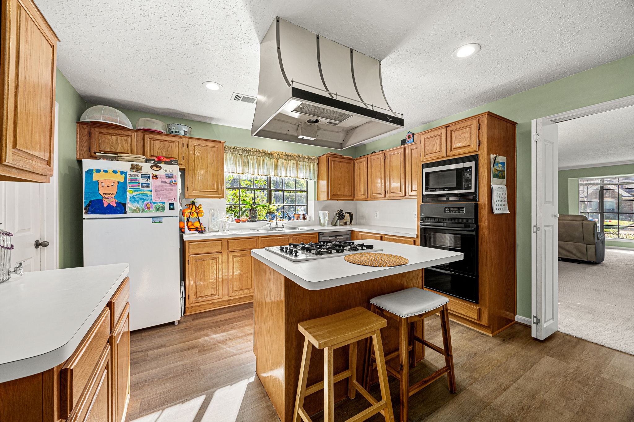 3402 Deeds Road Houston, TX 77084 - Photo 14 of 35 a kitchen with stainless steel appliances a stove a refrigerator and a dining table