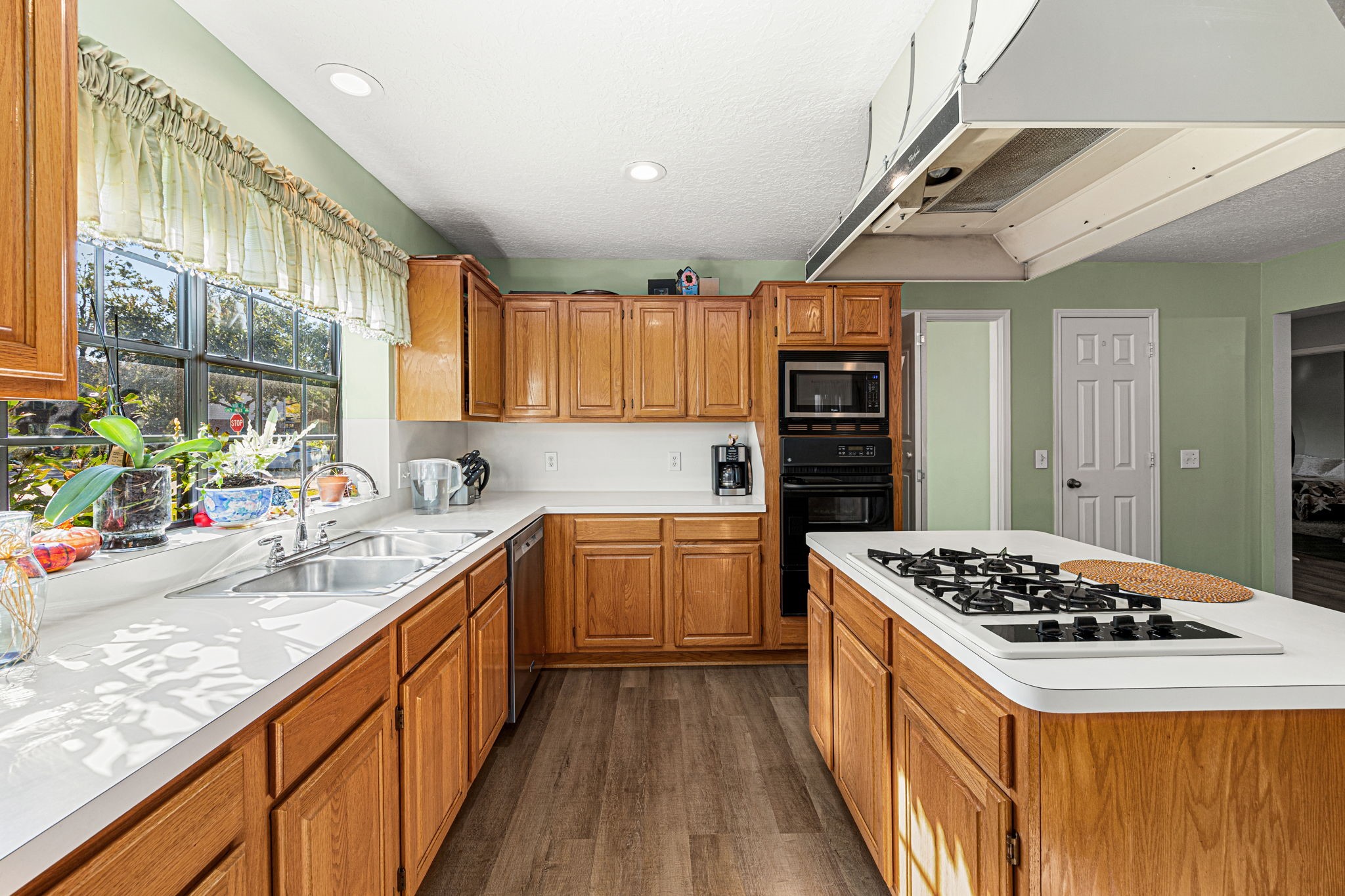 3402 Deeds Road Houston, TX 77084 - Photo 15 of 35 a kitchen with stainless steel appliances kitchen island a large stove a sink dishwasher and wooden cabinets with wooden floor