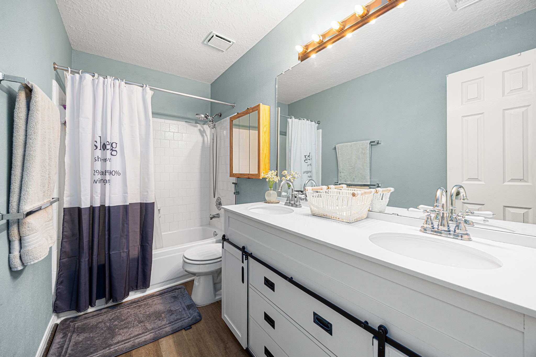 3402 Deeds Road Houston, TX 77084 - Photo 31 of 35 a bathroom with a sink a toilet a mirror and shower curtain