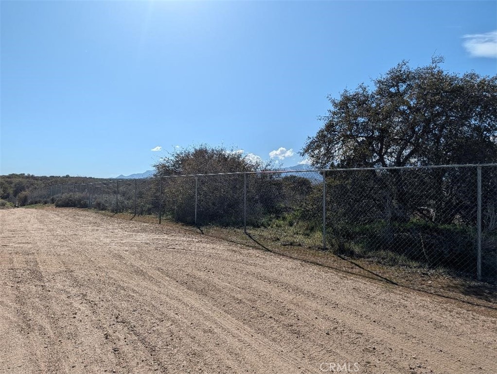 21 Atsina Road Phelan, CA 92371 - Photo 9 of 11 a view of a dry yard with wooden fence