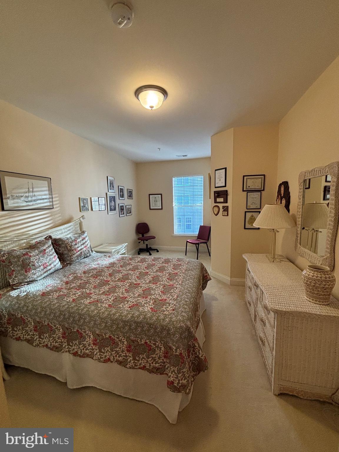 7300 Travertine Drive, Unit 302 Baltimore, MD 21209 - Photo 21 of 30 a bedroom with a large bed and a dresser