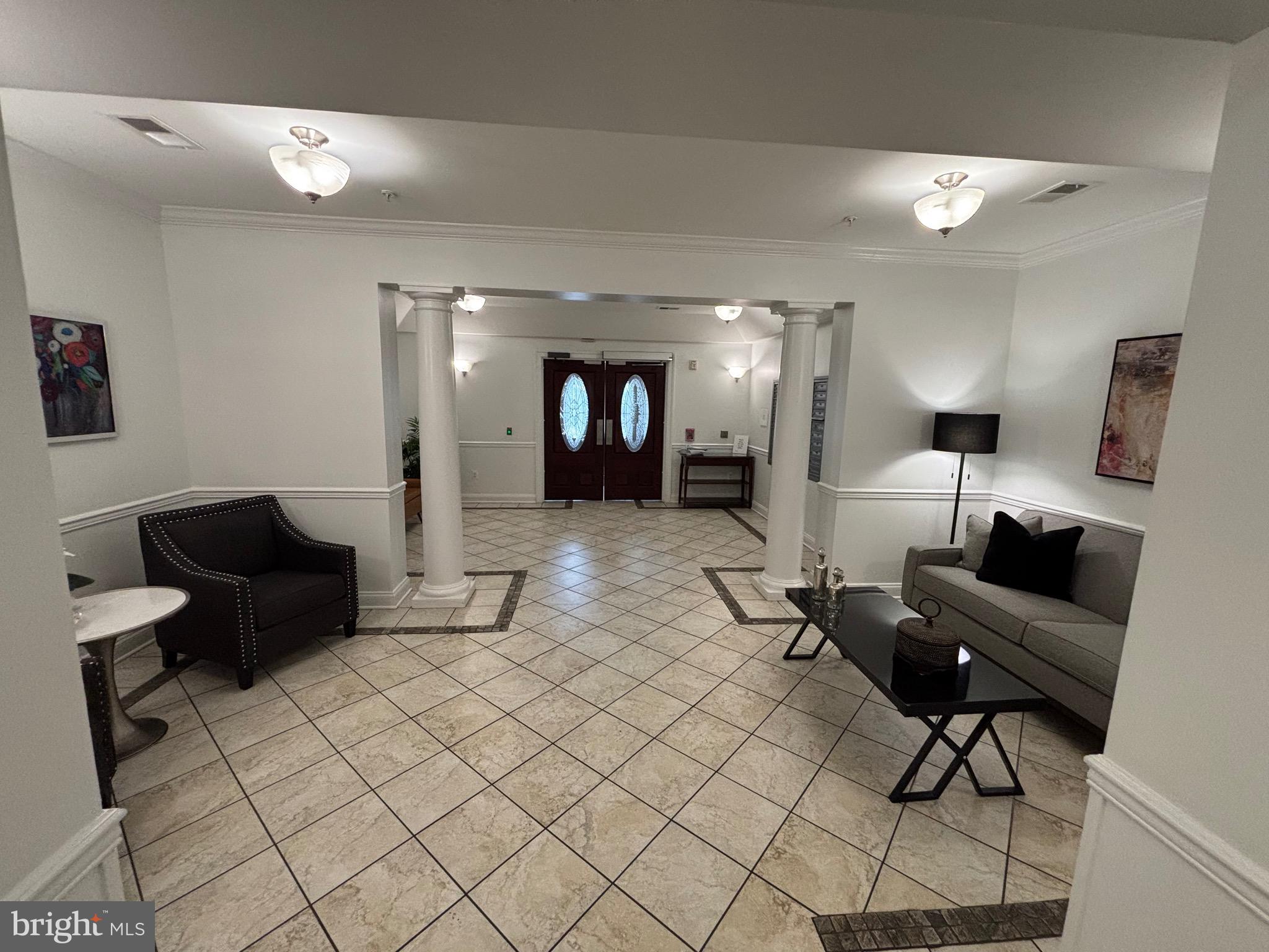 7300 Travertine Drive, Unit 302 Baltimore, MD 21209 - Photo 3 of 30 a living room with furniture and a mirror