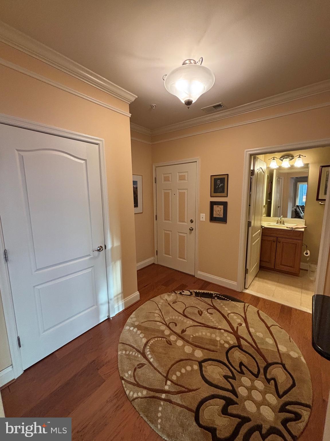 7300 Travertine Drive, Unit 302 Baltimore, MD 21209 - Photo 7 of 30 a bedroom with a bed and a view of bathroom