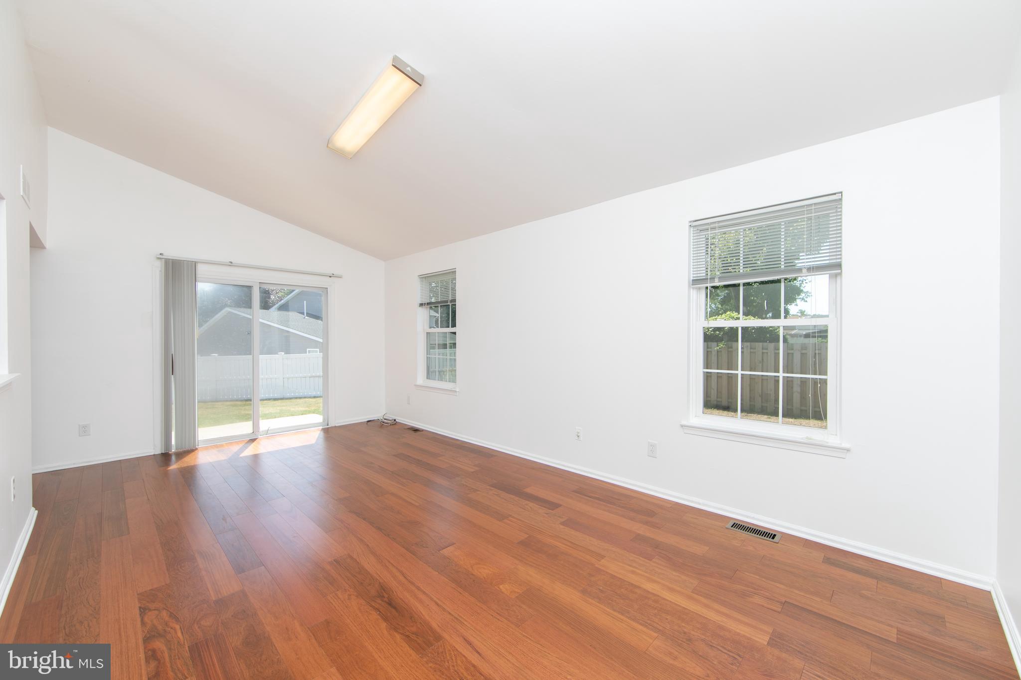 3007 Rampart Road Bensalem, PA 19020 - Photo 17 of 48 an empty room with wooden floor and windows