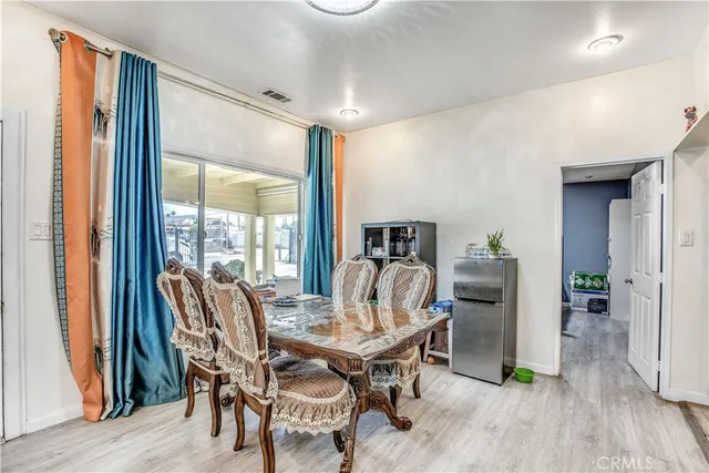 a bed sitting in a spacious bedroom next to a window