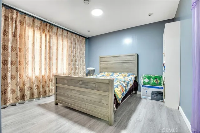 a bed sitting in a bedroom next to a window