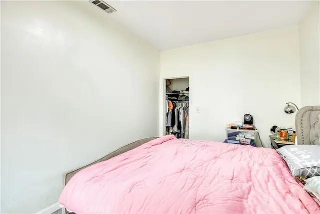 a bedroom with a bed and a chair