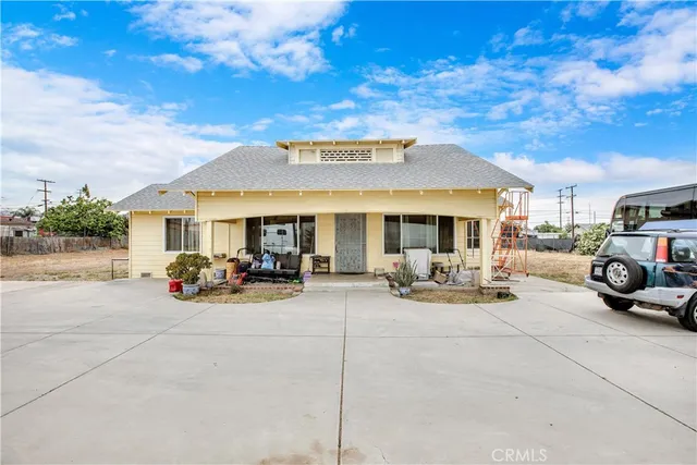 a view of a house with swimming pool and sitting area