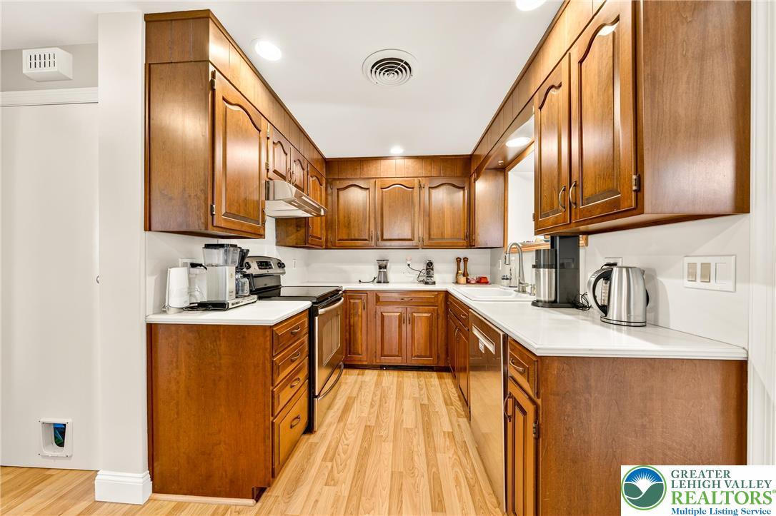 1814 Ruth Street Allentown, PA 18104 - Photo 18 of 47 a kitchen with stainless steel appliances granite countertop a sink a stove and a wooden floors