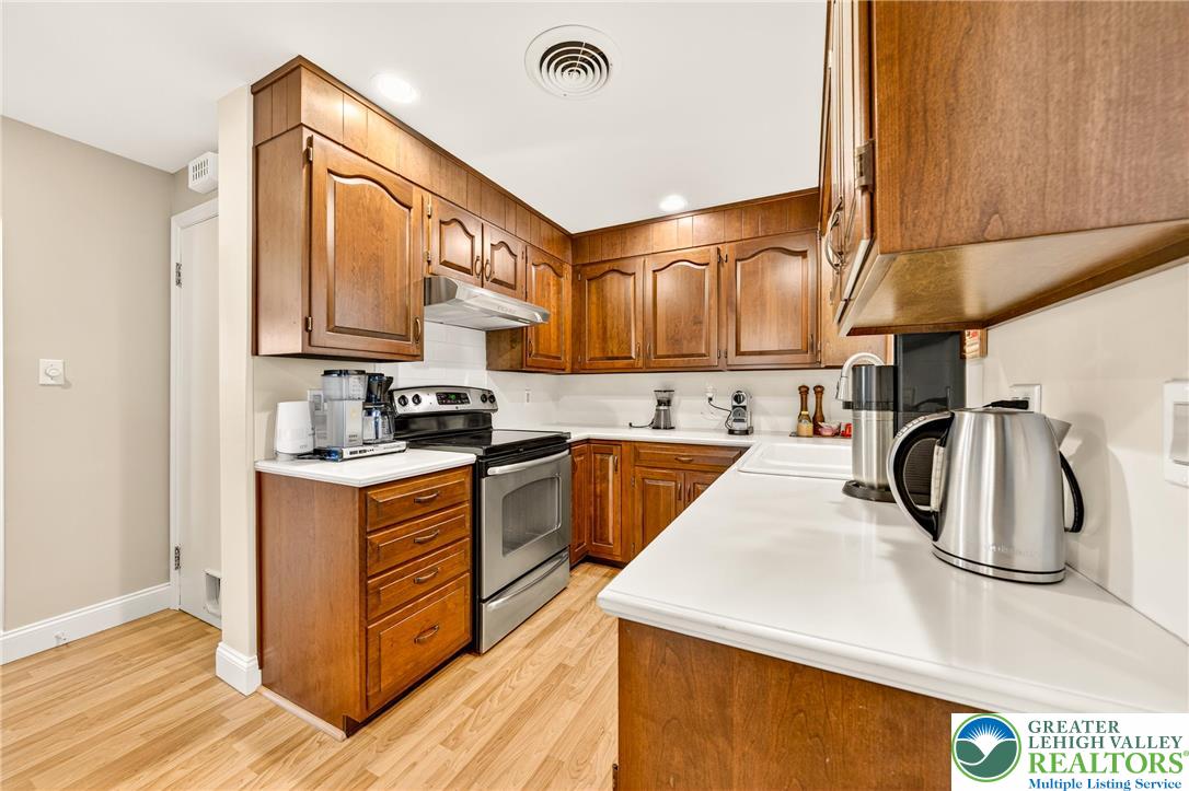 1814 Ruth Street Allentown, PA 18104 - Photo 21 of 47 a kitchen with stainless steel appliances granite countertop a sink a stove and a refrigerator