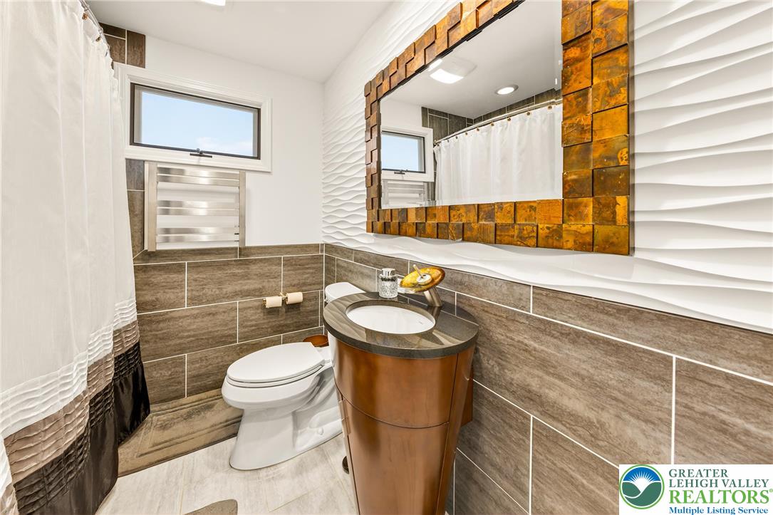 1814 Ruth Street Allentown, PA 18104 - Photo 31 of 47 a bathroom with a sink a toilet and a mirror