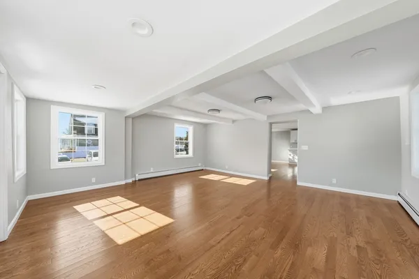 wooden floor in an empty room with a window