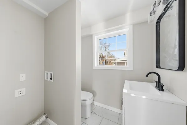 a bathroom with a toilet sink and mirror