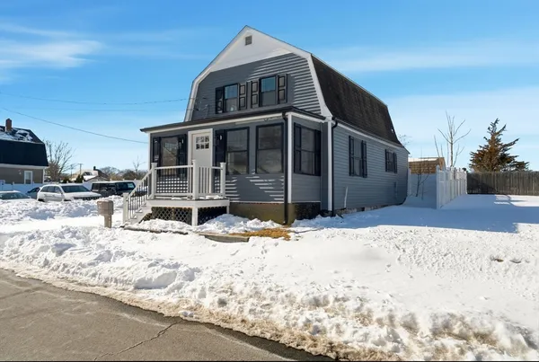 a view of a house with snow in the background